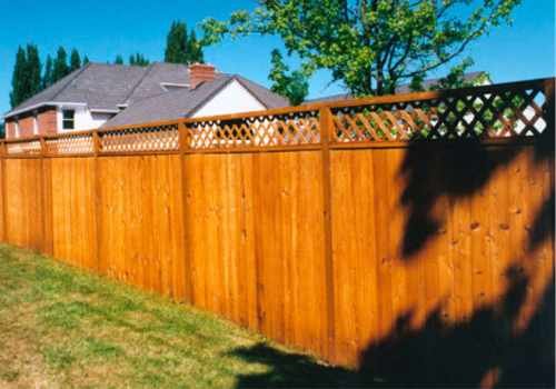 A sturdy wood fence with a decorative lattice top was installed in Lubbock, Texas, enclosing a residential backyard.